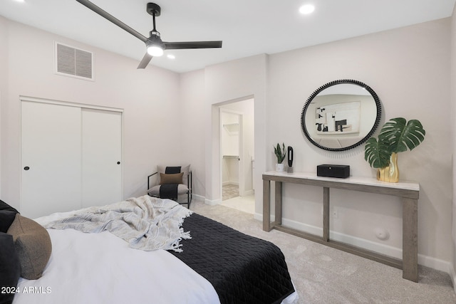 bedroom with ceiling fan, a closet, and light colored carpet