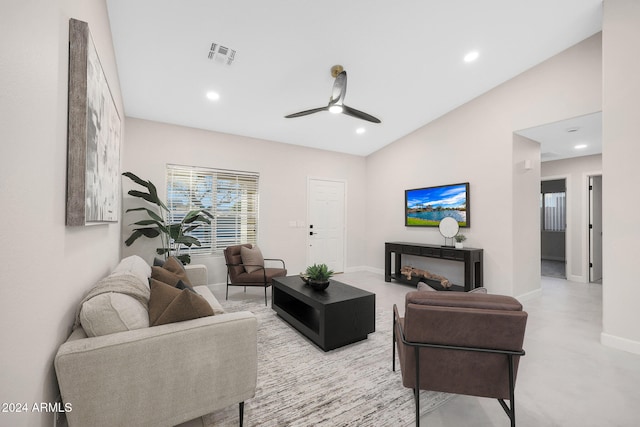 living room with ceiling fan, a fireplace, and vaulted ceiling