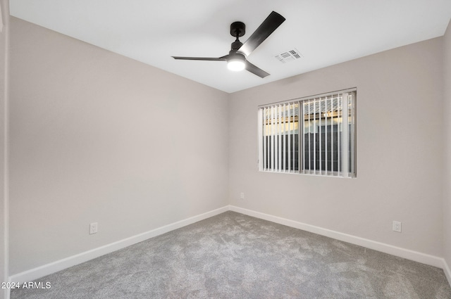 carpeted empty room featuring ceiling fan