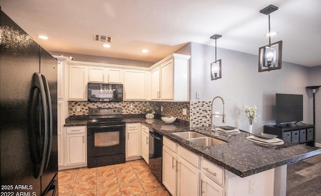 kitchen with a sink, a peninsula, backsplash, visible vents, and black appliances