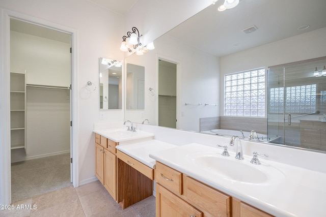 6230 W Montebello Way, Florence, AZ 85132 - full bath with double vanity, a walk in closet, a bath, a shower stall, and tile patterned flooring