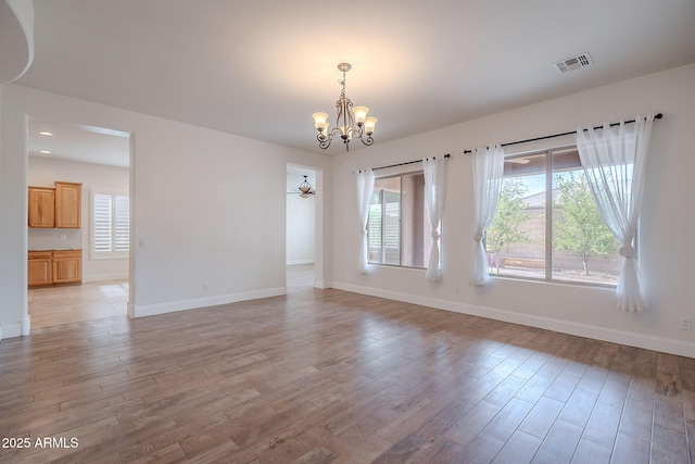 6230 W Montebello Way, Florence, AZ 85132 - spare room with a chandelier and light wood-style floors
