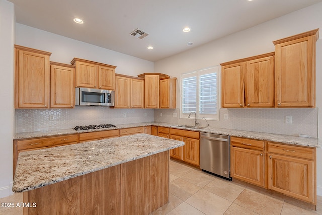 6230 W Montebello Way, Florence, AZ 85132 - kitchen featuring appliances with stainless steel finishes, backsplash, light stone counters, light tile patterned floors, and recessed lighting
