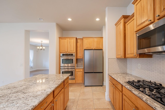 6230 W Montebello Way, Florence, AZ 85132 - kitchen featuring appliances with stainless steel finishes, backsplash, light stone countertops, and recessed lighting