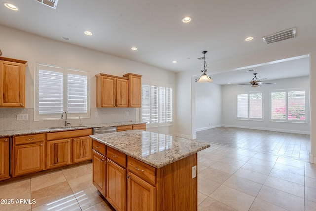 6230 W Montebello Way, Florence, AZ 85132 - kitchen with ceiling fan, light tile patterned flooring, a kitchen island, recessed lighting, and light stone counters