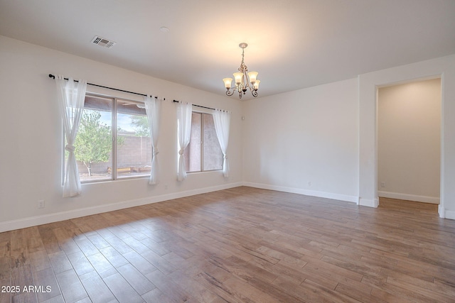 6230 W Montebello Way, Florence, AZ 85132 - unfurnished room featuring a chandelier and wood finished floors