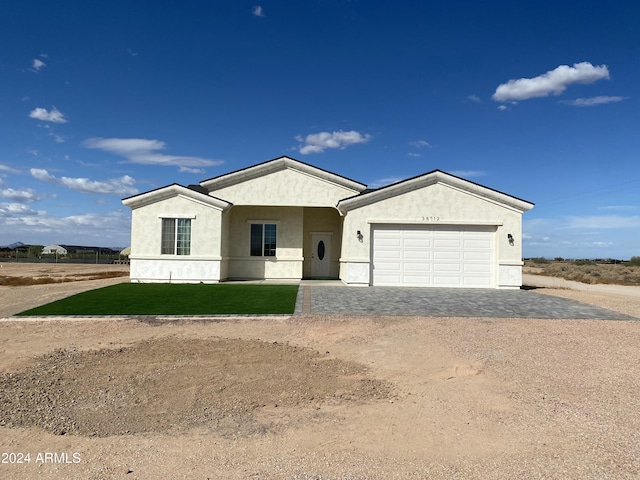 38712 W Sherman St, Tonopah, AZ 85354 - ranch-style house featuring decorative driveway, an attached garage, stucco siding, and a front lawn
