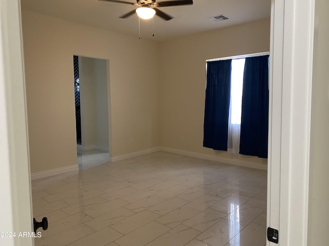 38712 W Sherman St, Tonopah, AZ 85354 - unfurnished room with a ceiling fan, light marble finish flooring, and baseboards
