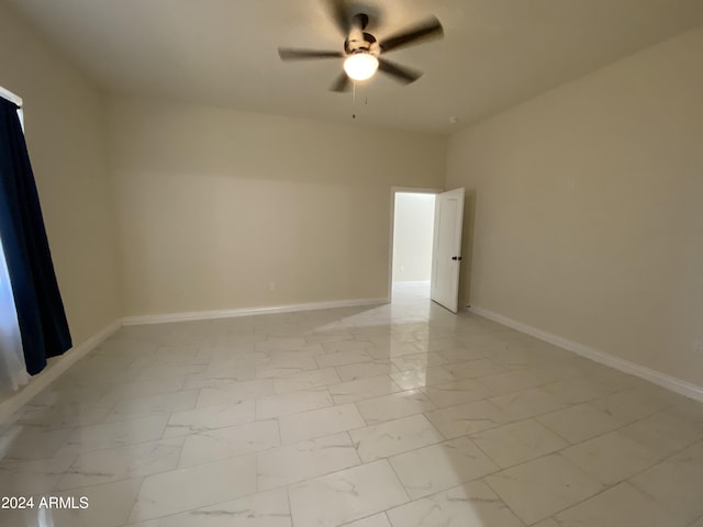 38712 W Sherman St, Tonopah, AZ 85354 - unfurnished room with ceiling fan, light marble finish floors, and baseboards