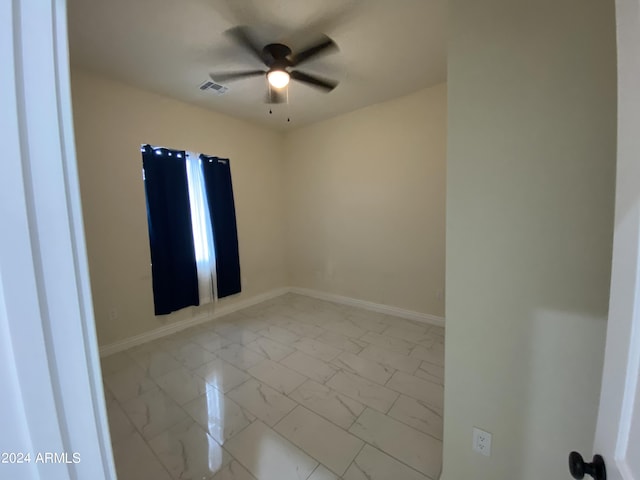 38712 W Sherman St, Tonopah, AZ 85354 - spare room with light marble finish floors, ceiling fan, and baseboards