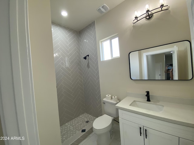 38712 W Sherman St, Tonopah, AZ 85354 - bathroom featuring vanity, toilet, a tile shower, and marble look tiles