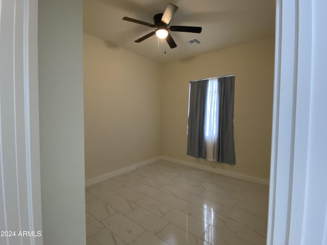 38712 W Sherman St, Tonopah, AZ 85354 - unfurnished room featuring marble look tile flooring, baseboards, and a ceiling fan