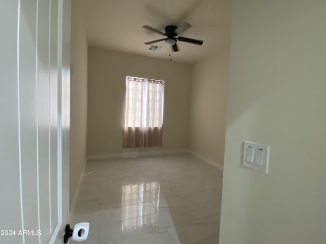 38712 W Sherman St, Tonopah, AZ 85354 - empty room featuring marble finish floors, a ceiling fan, and baseboards