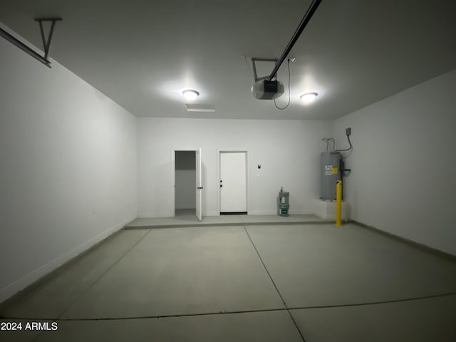 38712 W Sherman St, Tonopah, AZ 85354 - garage featuring water heater, a garage door opener, and baseboards