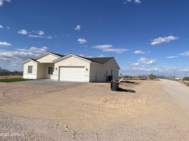 38712 W Sherman St, Tonopah, AZ 85354 - single story home featuring dirt driveway, a garage, and stucco siding
