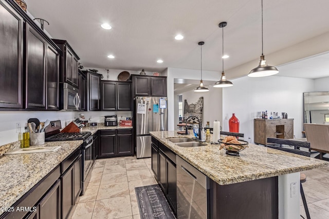 4216 W Harwell Rd, Laveen, AZ 85339 - kitchen featuring appliances with stainless steel finishes, a sink, light stone countertops, recessed lighting, and a kitchen island with sink