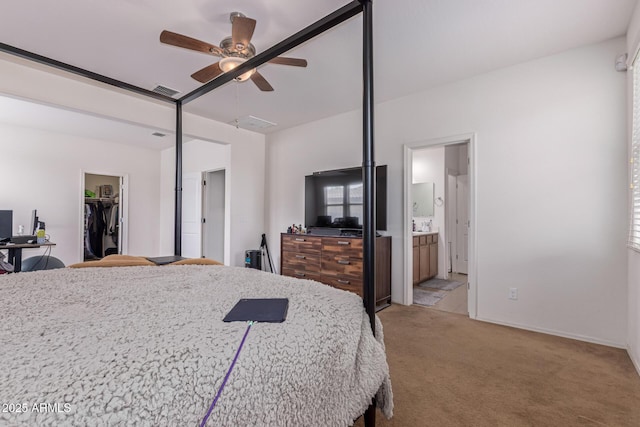 4216 W Harwell Rd, Laveen, AZ 85339 - bedroom with light carpet, a spacious closet, ensuite bath, a ceiling fan, and a closet