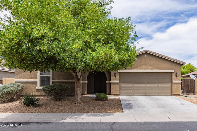 4216 W Harwell Rd, Laveen, AZ 85339 - view of property hidden behind natural elements featuring an attached garage, stucco siding, and driveway
