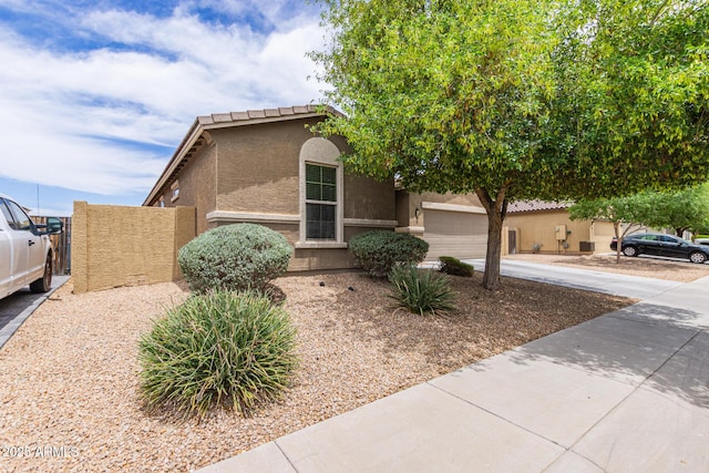 4216 W Harwell Rd, Laveen, AZ 85339 - view of front facade with concrete driveway, stucco siding, and a garage