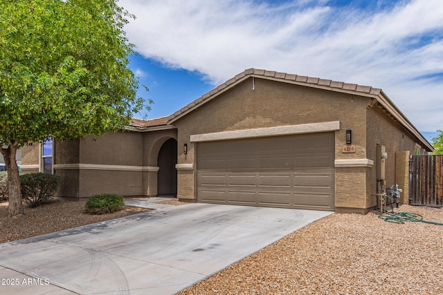 4216 W Harwell Rd, Laveen, AZ 85339 - ranch-style house featuring a garage, concrete driveway, stucco siding, and a tiled roof