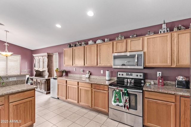 kitchen with light stone counters, stainless steel appliances, decorative light fixtures, and light tile patterned floors