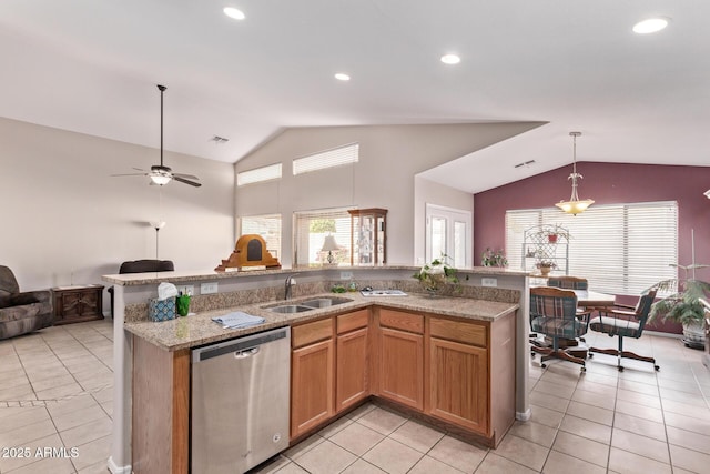 kitchen featuring sink, vaulted ceiling, stainless steel dishwasher, pendant lighting, and a kitchen island with sink