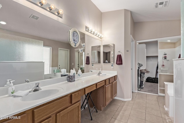 bathroom with tile patterned floors and vanity