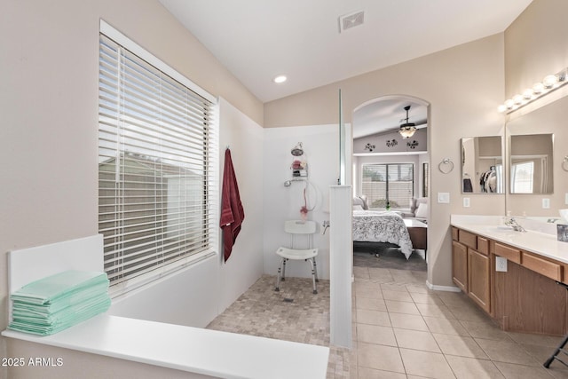 bathroom featuring vanity, vaulted ceiling, tile patterned floors, and ceiling fan