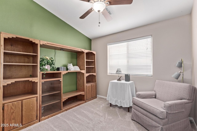 living area with ceiling fan, lofted ceiling, and carpet