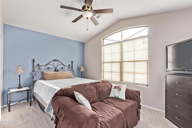 bedroom featuring multiple windows, vaulted ceiling, light carpet, and ceiling fan