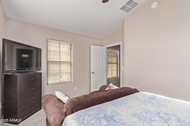 carpeted bedroom with vaulted ceiling and ceiling fan