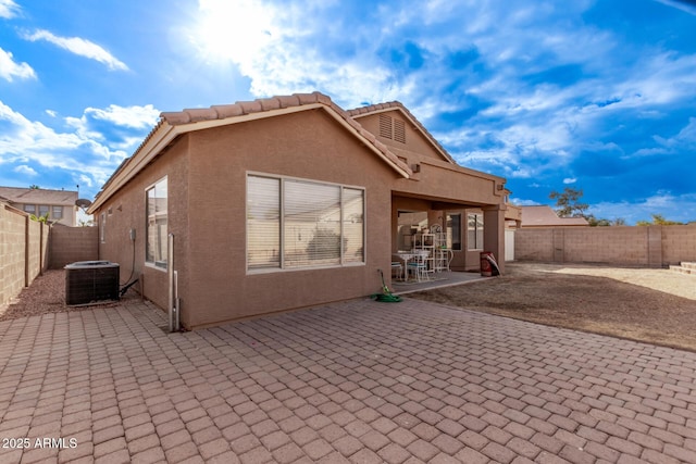 back of property featuring cooling unit and a patio area