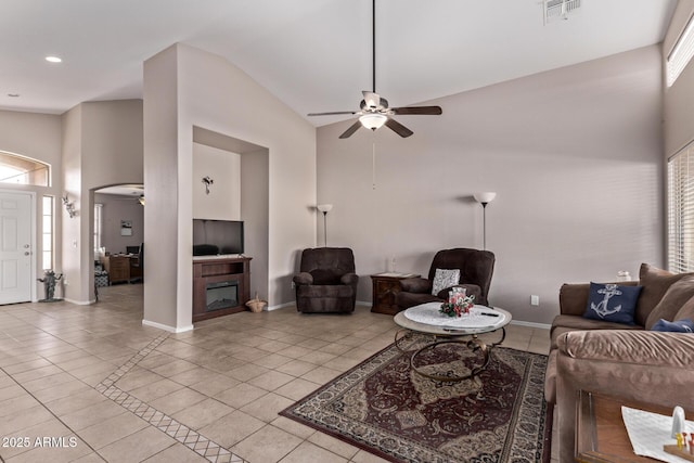 tiled living room with plenty of natural light, high vaulted ceiling, and ceiling fan