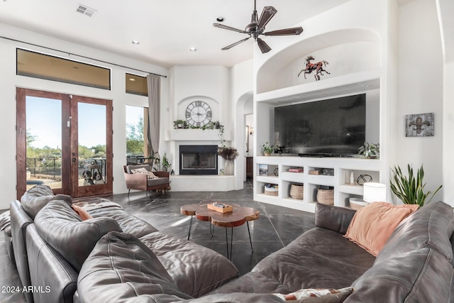 14129 E Barbie Ln, Scottsdale, AZ 85262 - living room featuring built in features, french doors, a ceiling fan, recessed lighting, and a fireplace with raised hearth