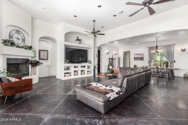 14129 E Barbie Ln, Scottsdale, AZ 85262 - living area with ceiling fan, arched walkways, built in features, a fireplace with raised hearth, and recessed lighting