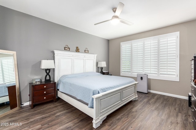 bedroom with dark hardwood / wood-style flooring, ceiling fan, and multiple windows