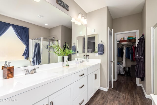 bathroom featuring a shower with door, vanity, and hardwood / wood-style flooring