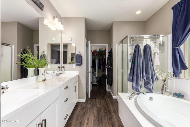 bathroom featuring hardwood / wood-style floors, separate shower and tub, and vanity