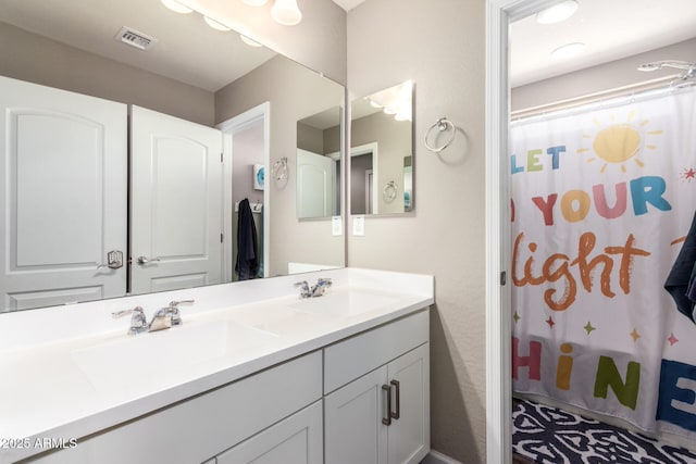 bathroom featuring shower / bath combo with shower curtain and vanity