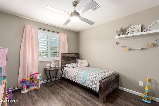 bedroom with dark hardwood / wood-style flooring and ceiling fan