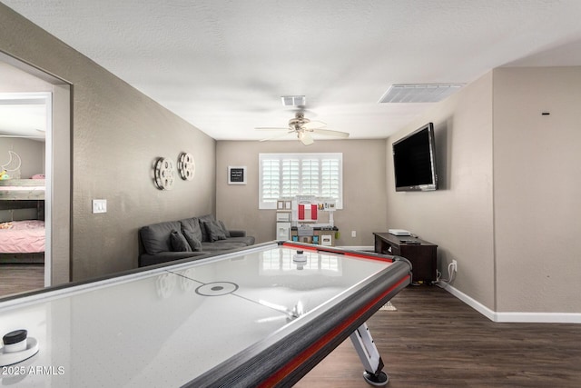 recreation room with ceiling fan and dark hardwood / wood-style floors