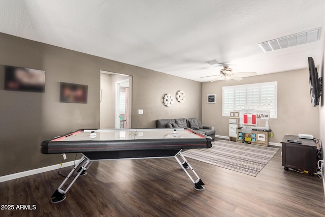 rec room with ceiling fan and dark hardwood / wood-style flooring