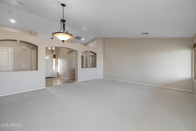 unfurnished living room featuring lofted ceiling and light colored carpet