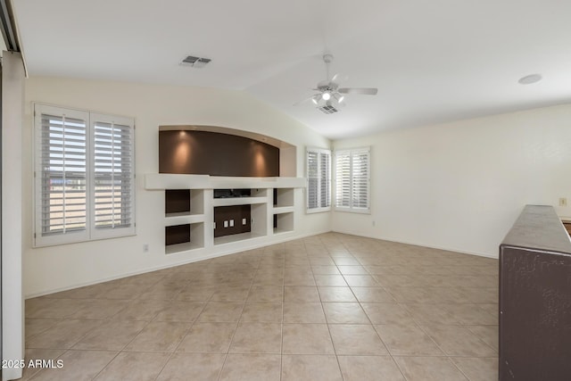 unfurnished living room featuring vaulted ceiling, light tile patterned floors, ceiling fan, and built in shelves