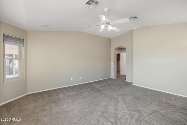 carpeted spare room with vaulted ceiling and ceiling fan