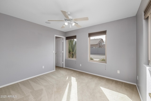 unfurnished bedroom featuring light carpet and ceiling fan