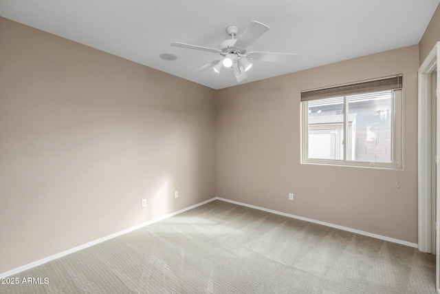 carpeted empty room featuring ceiling fan