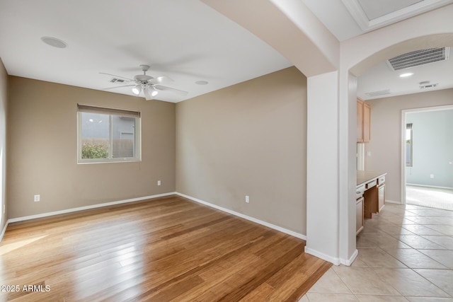 empty room featuring ceiling fan and light hardwood / wood-style flooring