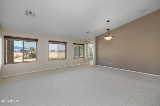 spare room with vaulted ceiling and carpet floors