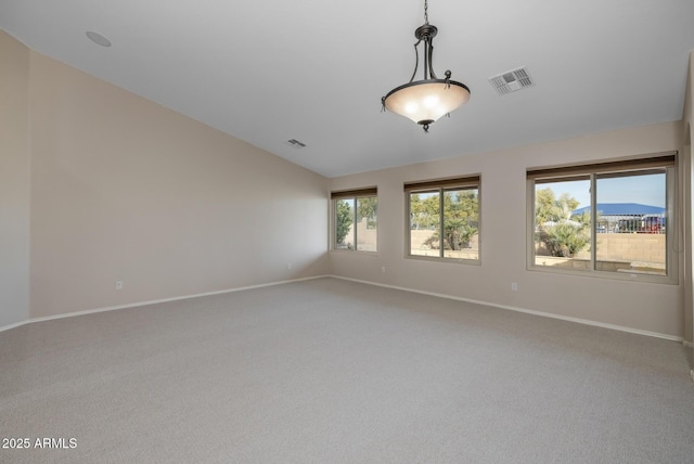 spare room featuring a mountain view, vaulted ceiling, and carpet